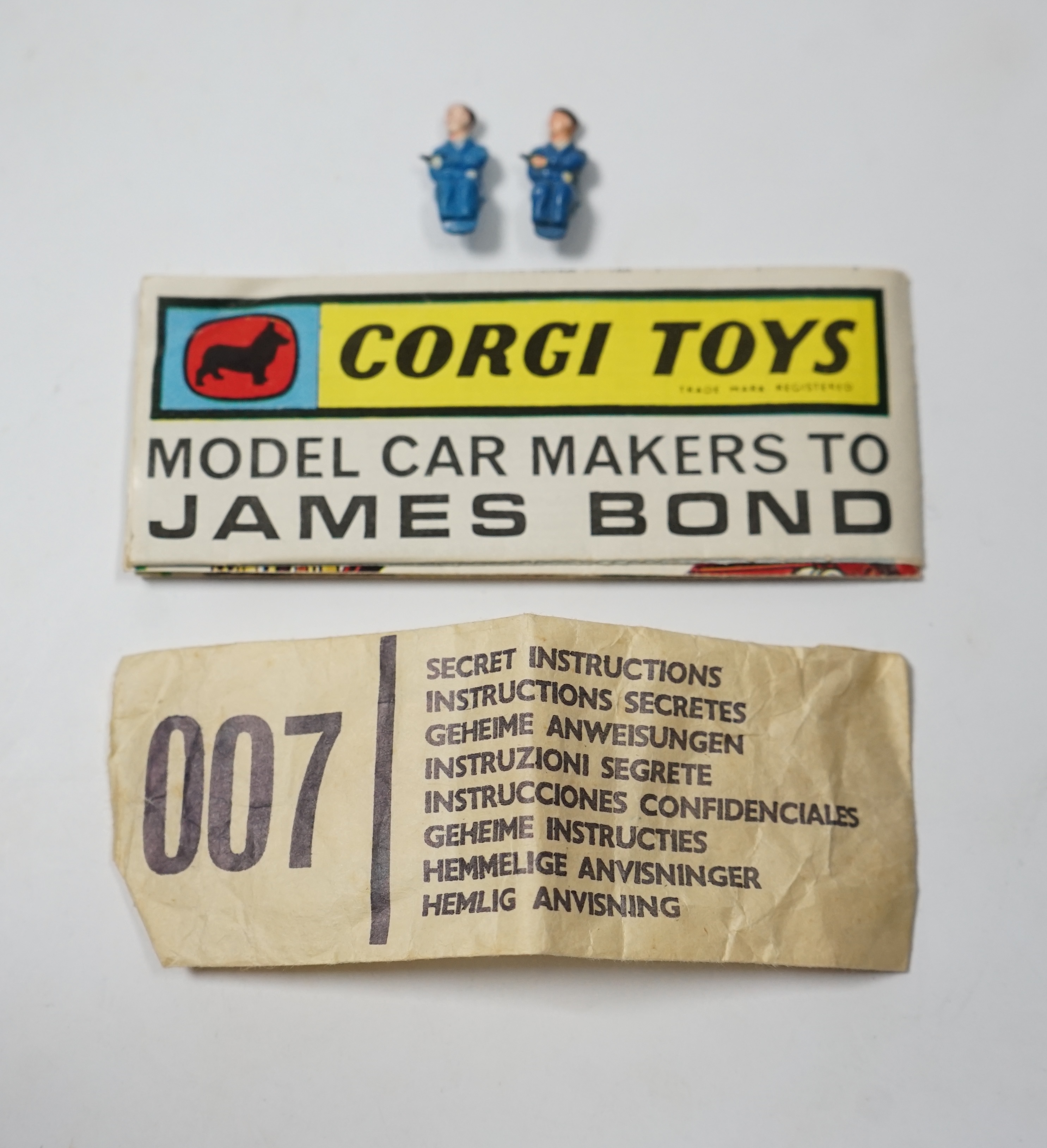 A boxed Corgi Toys James Bond 007 Aston Martin DB5 (261), a gold Aston Martin, with inner display stand, the envelope for the secret instructions (contents missing), the correct James Bond advertising leaflet and two pas